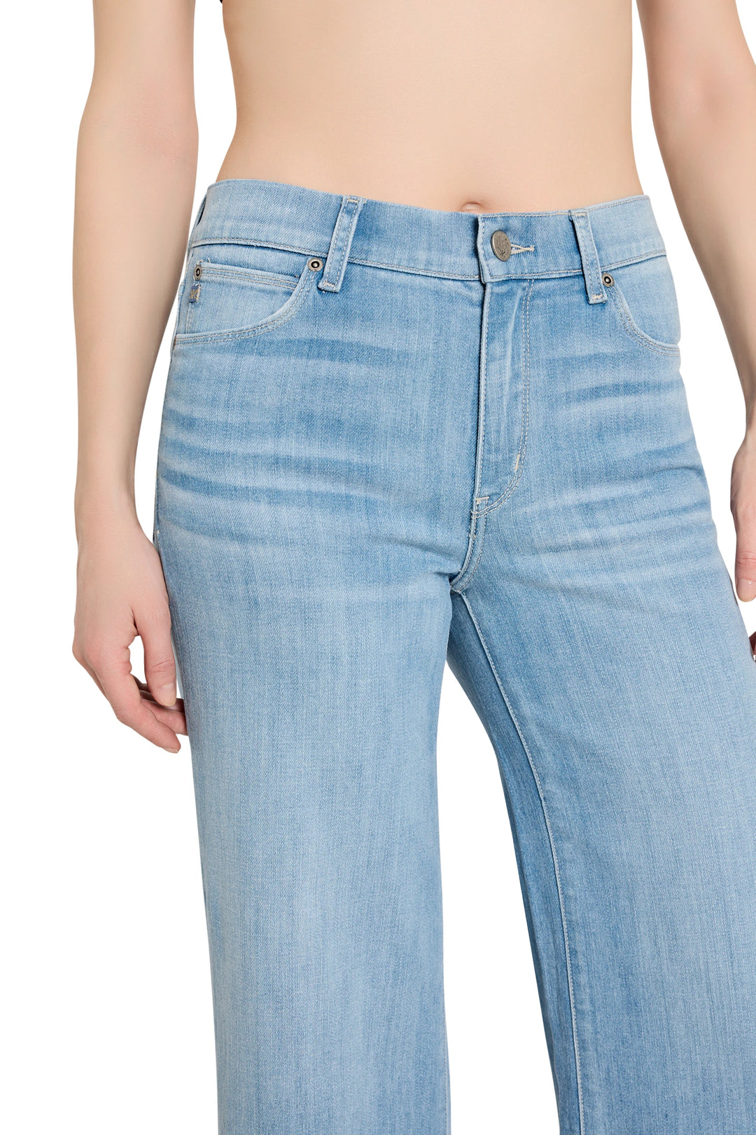 Light blue jeans worn by a person on a white background