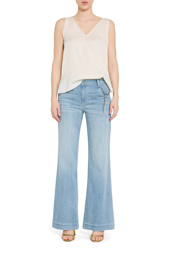 High-rise wide-leg denim trouser with tailored waistband and visible seam detail, front view on white.