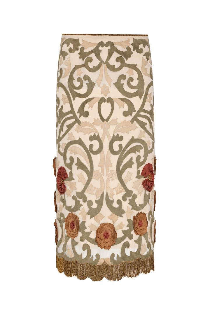 A-line organza skirt with green patterns, red appliqué, gold fringe trim, suede embroidery; front view on white.