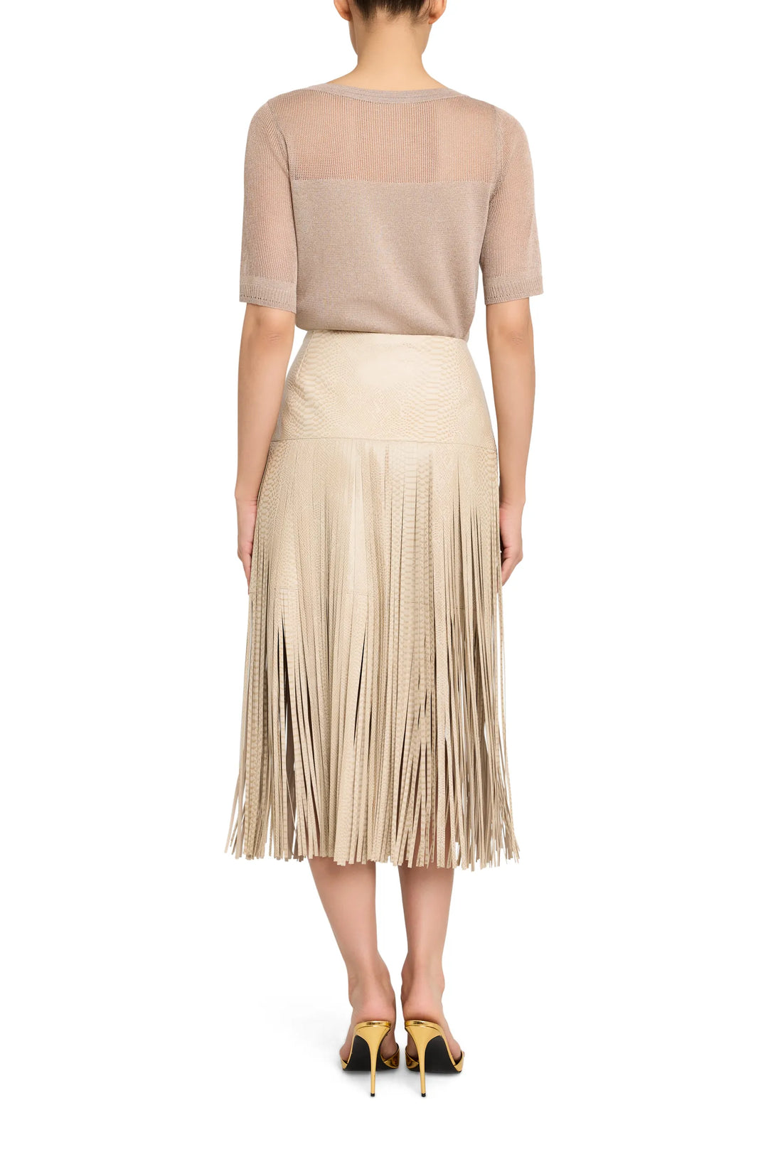 Fringe leather mini skirt with straight silhouette and exposed seams, back view on model.