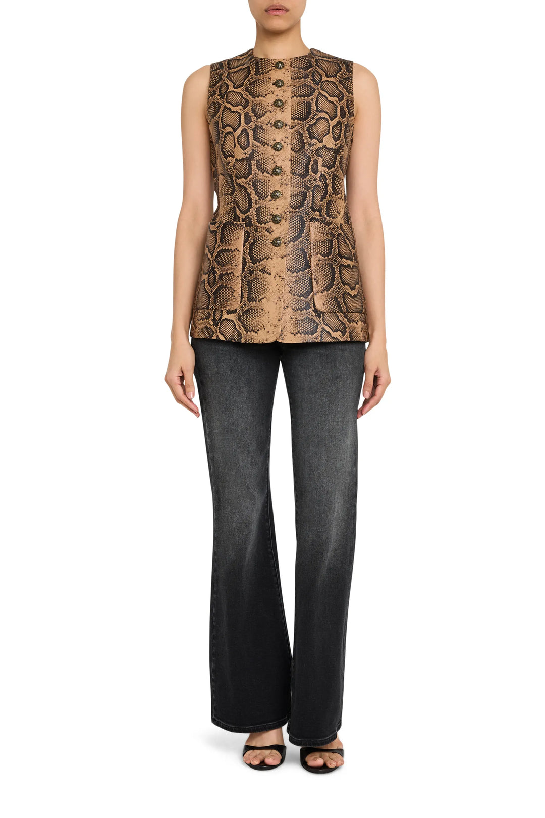 Sleeveless leather vest with tailored fit, front button closure, and bold printed pattern; front view on model.