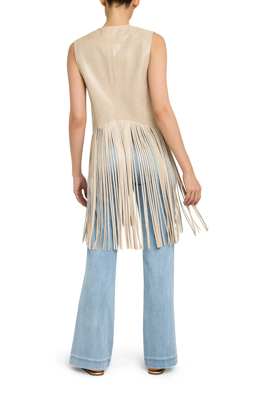 Sleeveless leather vest with fringe trim and open front, straight silhouette. Back view on model.