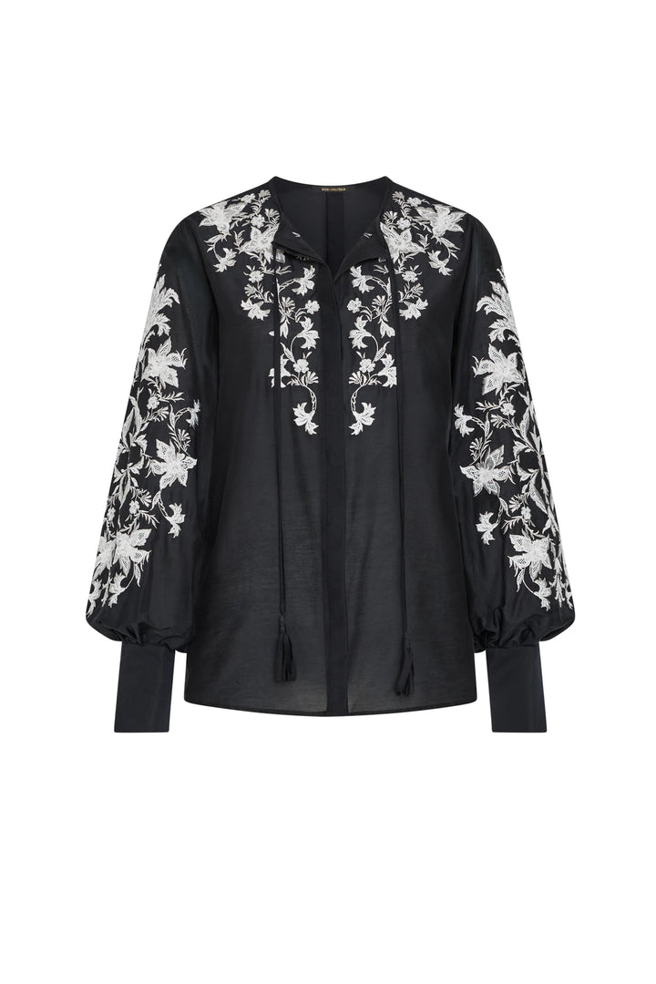 Black blouse with white floral embroidery on a white background