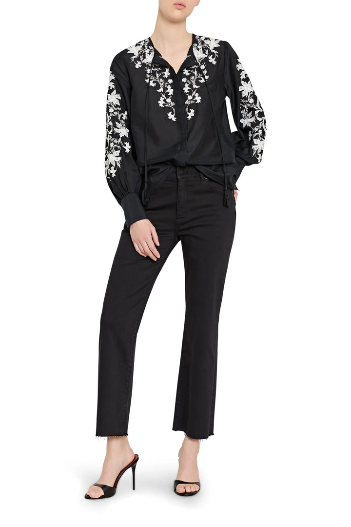 Black outfit with floral embroidery on a white background