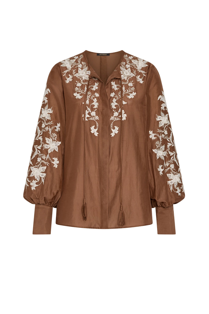 Cotton blouse with floral embroidery, tie neckline, relaxed fit silhouette. Front view on white.