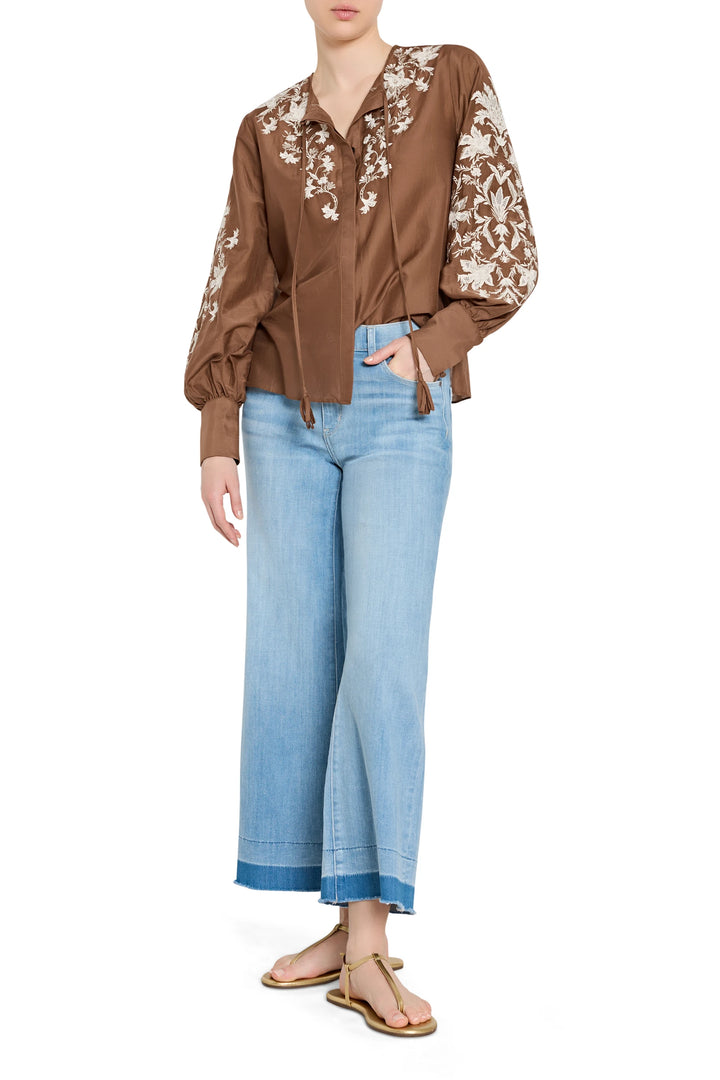 Relaxed, hand-embroidered cotton blouse with bishop sleeves and pintucked bodice; front view on model.