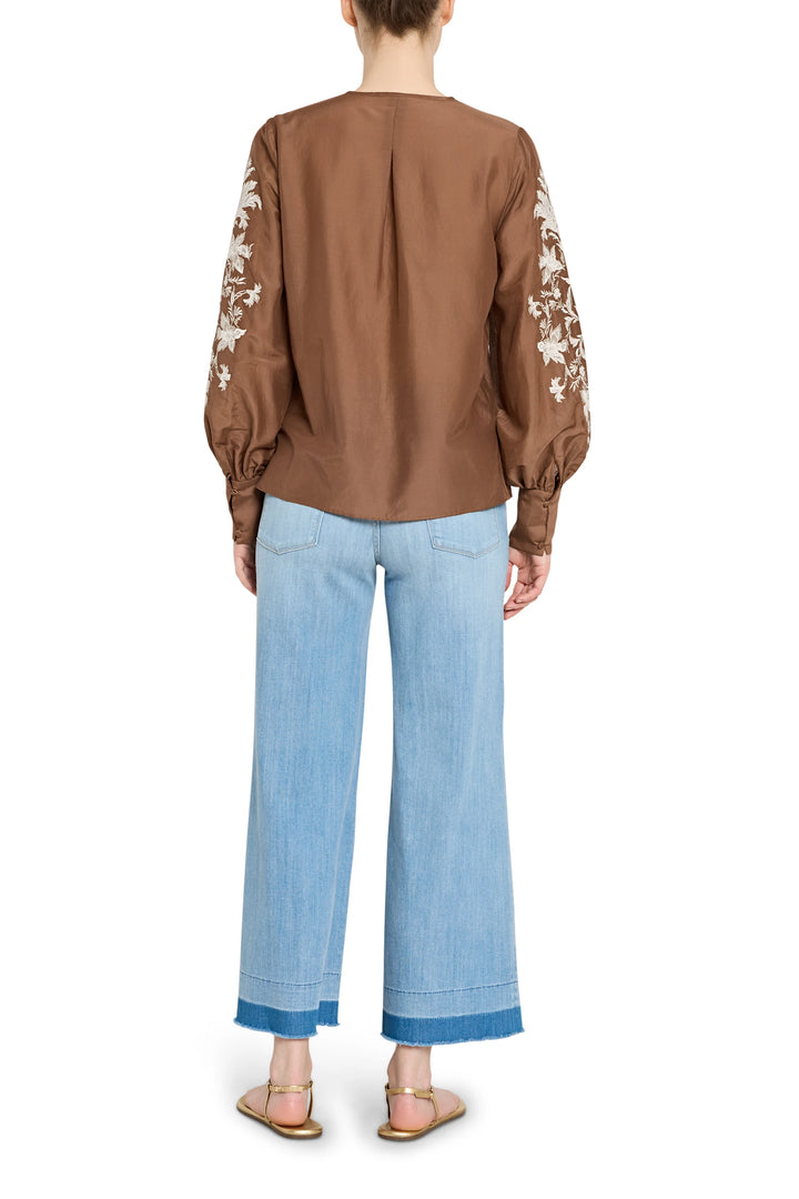 Relaxed, embroidered cotton blouse with voluminous sleeves and keyhole back, back view on model.