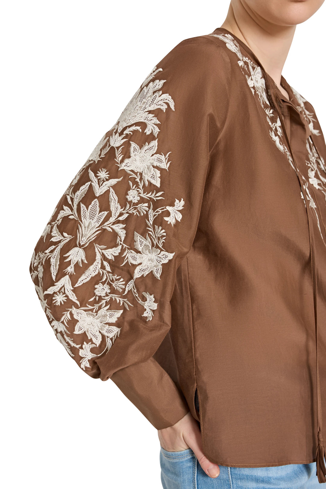 Cotton blouse with embroidered floral bishop sleeves, pintucked bodice, relaxed fit. Front view on model.