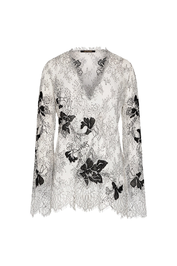 Lace top with black floral embroidery on a white background