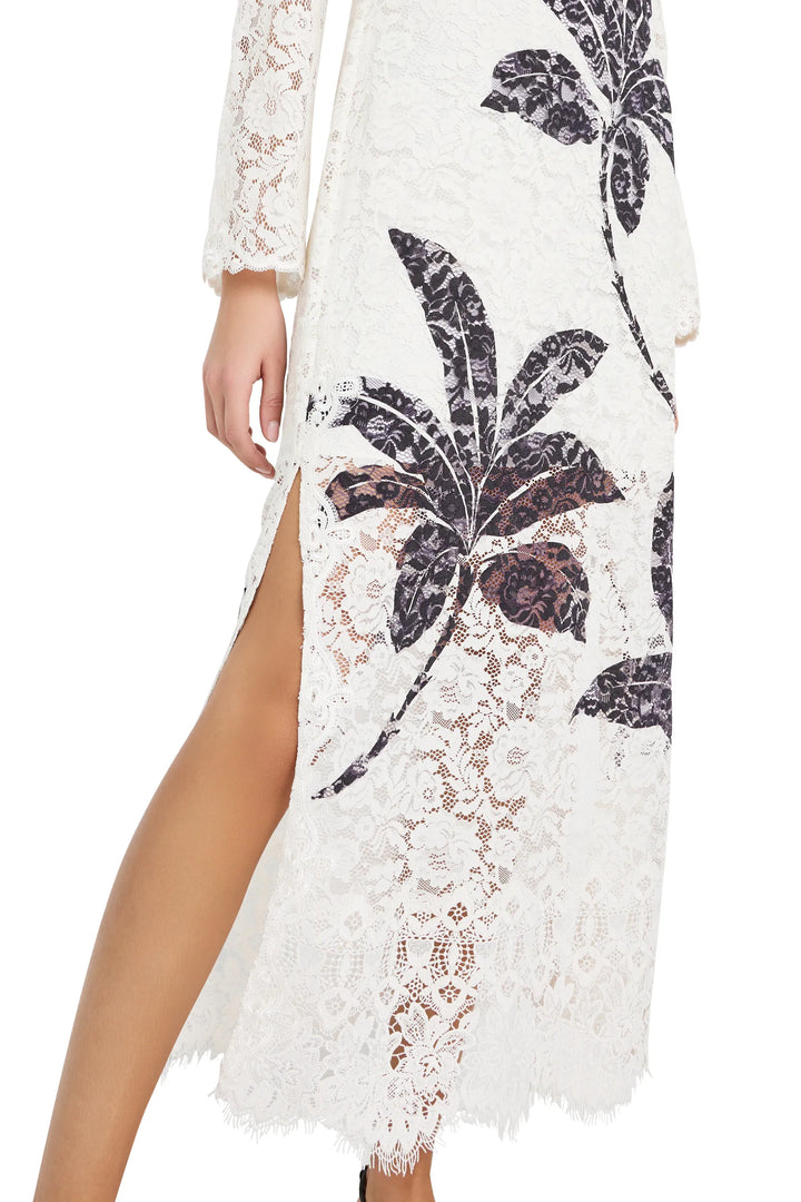 Maxi dress with long sleeves, high side slit, allover botanical print, fluid silhouette; front view on model.