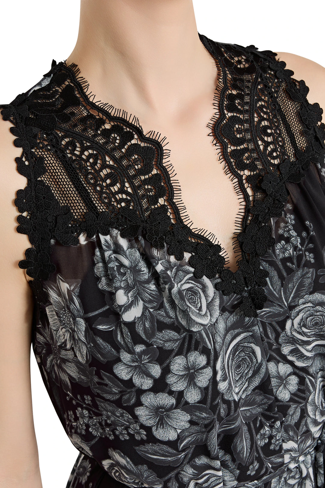 Black lace top with floral embroidery on a white background