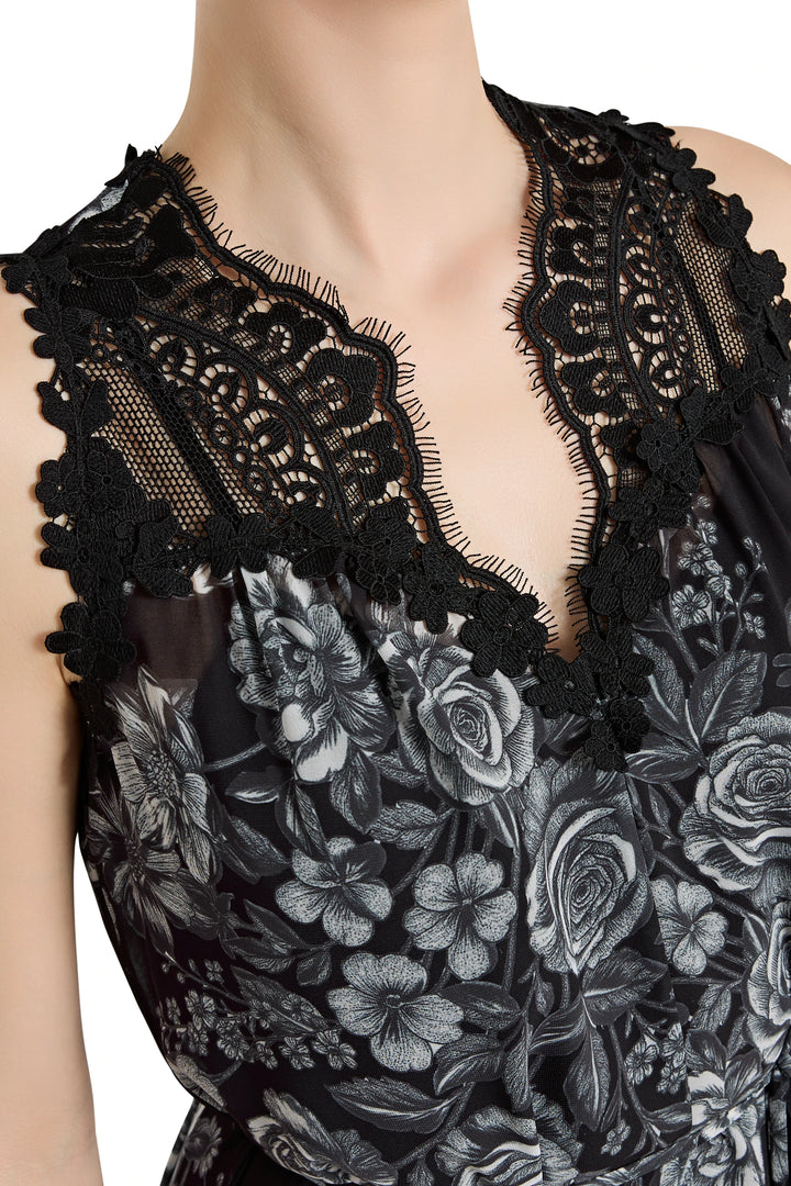 Black lace top with floral embroidery on a white background
