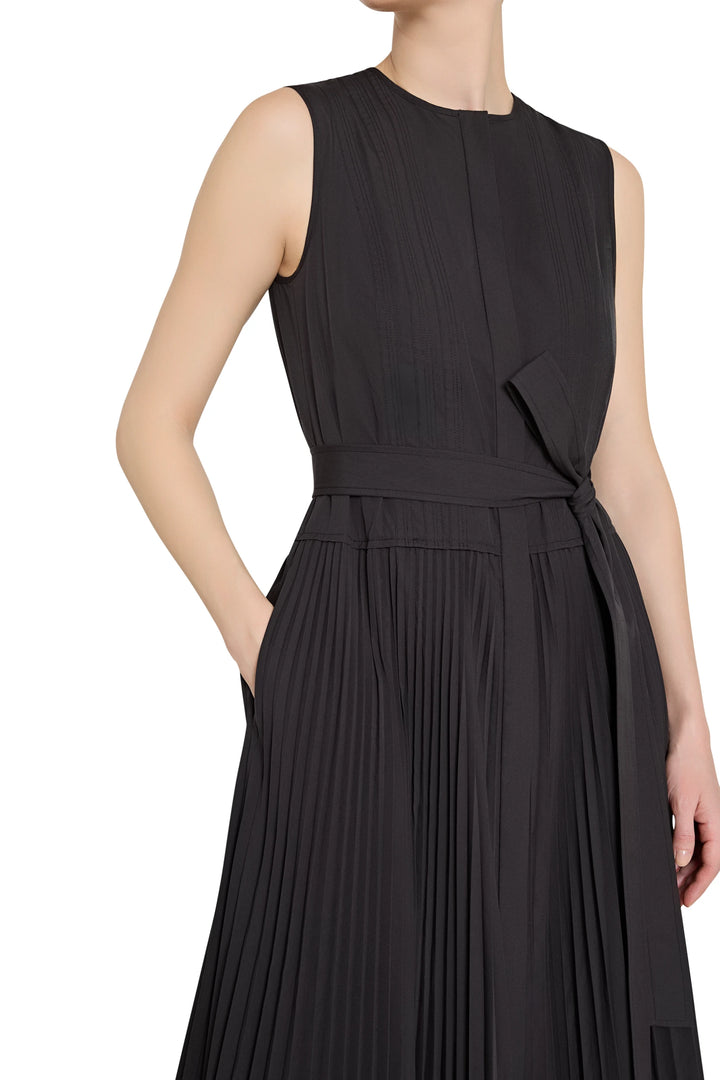 Black sleeveless dress with a belt on a white background