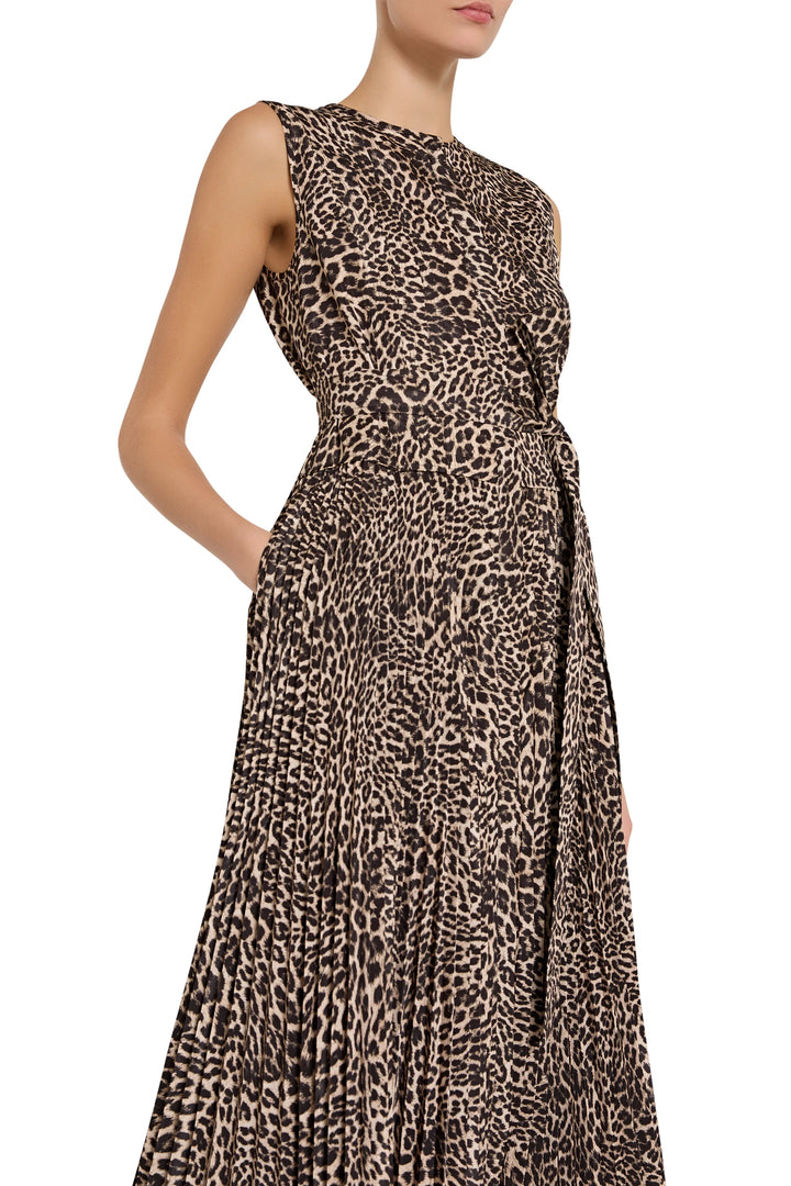 Sleeveless midi dress with belted waist, side pockets, and animal print crepe, fitted bodice; front view on model.