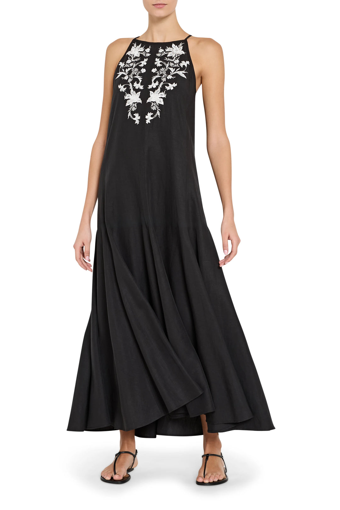 Black sleeveless dress with white floral embroidery on a white background
