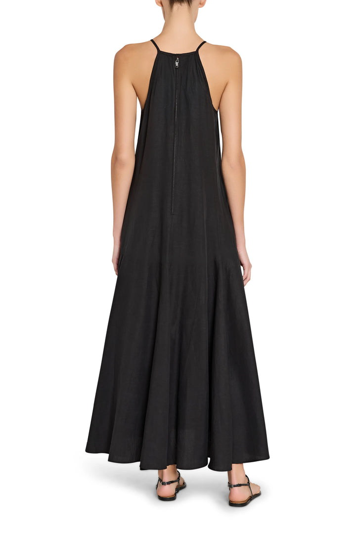 Black halter neck dress worn by a person on a white background