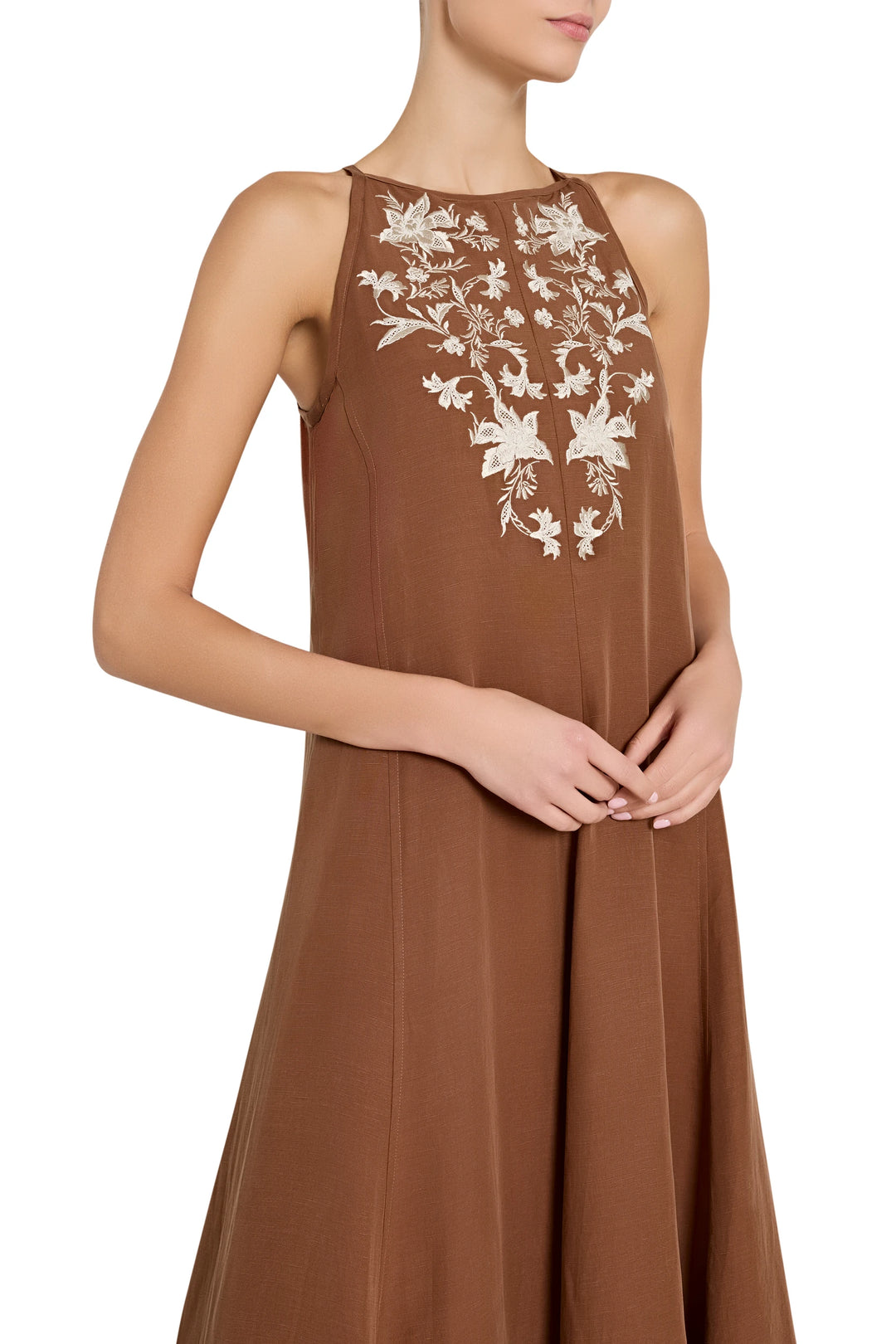 Sleeveless maxi dress with hand-embroidered bodice, lace chest detail, fluid skirt; front view on model.