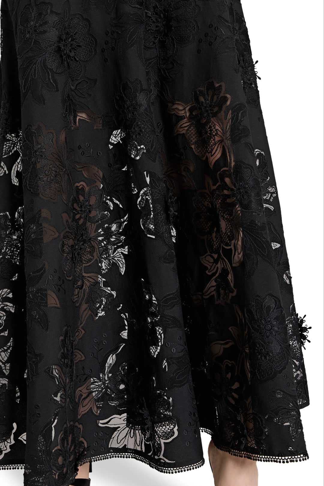 Black lace dress with floral patterns on a white background