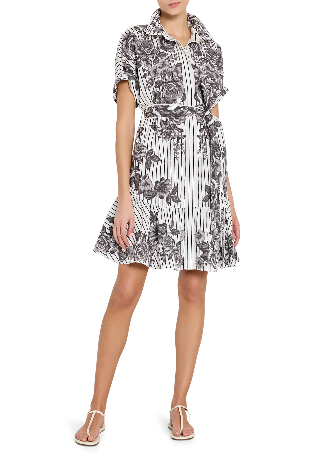 Woman wearing a floral and striped dress on a white background