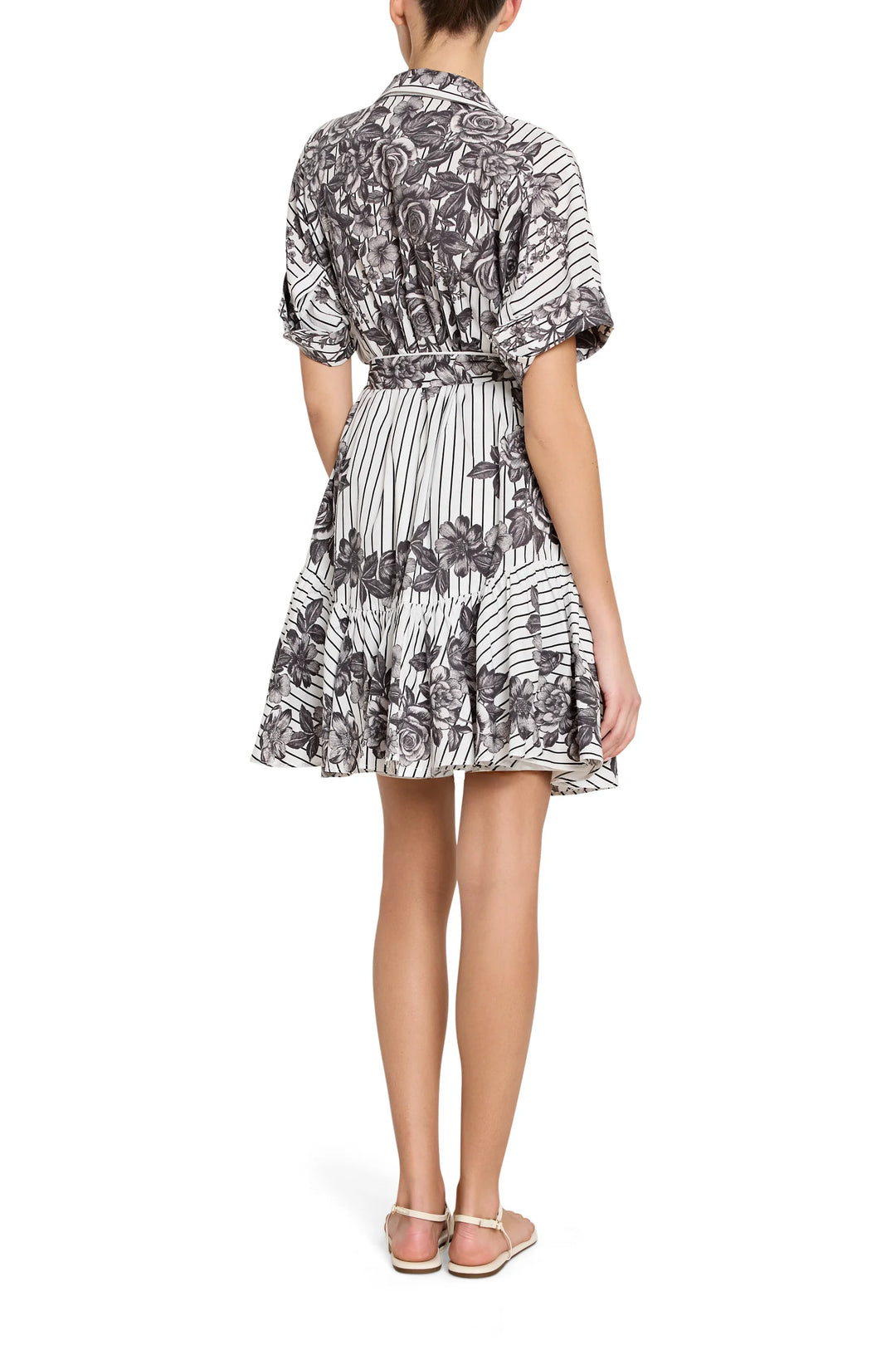 Woman wearing a patterned dress on a white background