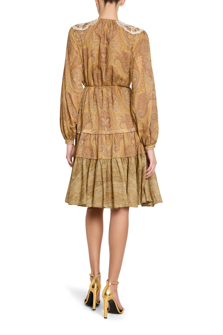 Tiered ruffled dress with flowing silhouette and defined waist, soft fabric, tier seams; back view on model.