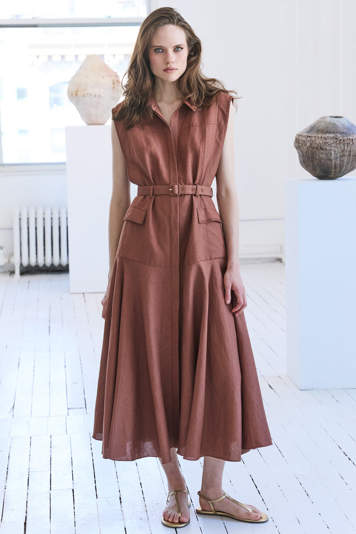 Linen midi dress with belted waist, relaxed silhouette, and short sleeves; front view on model.