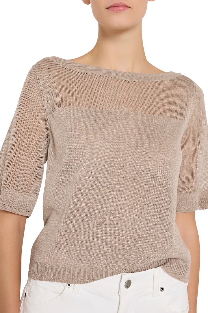 Beige knit top worn by a person on a white background
