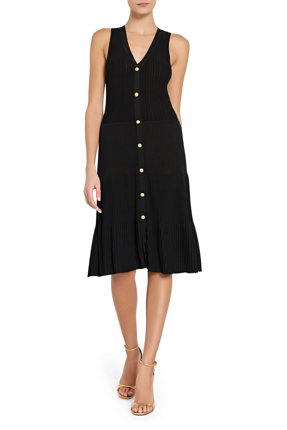 Black sleeveless dress with buttons on a white background