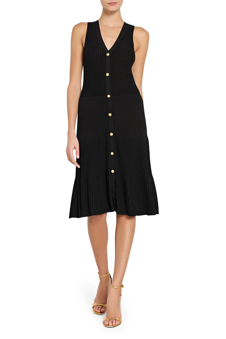 Black sleeveless dress with buttons on a white background