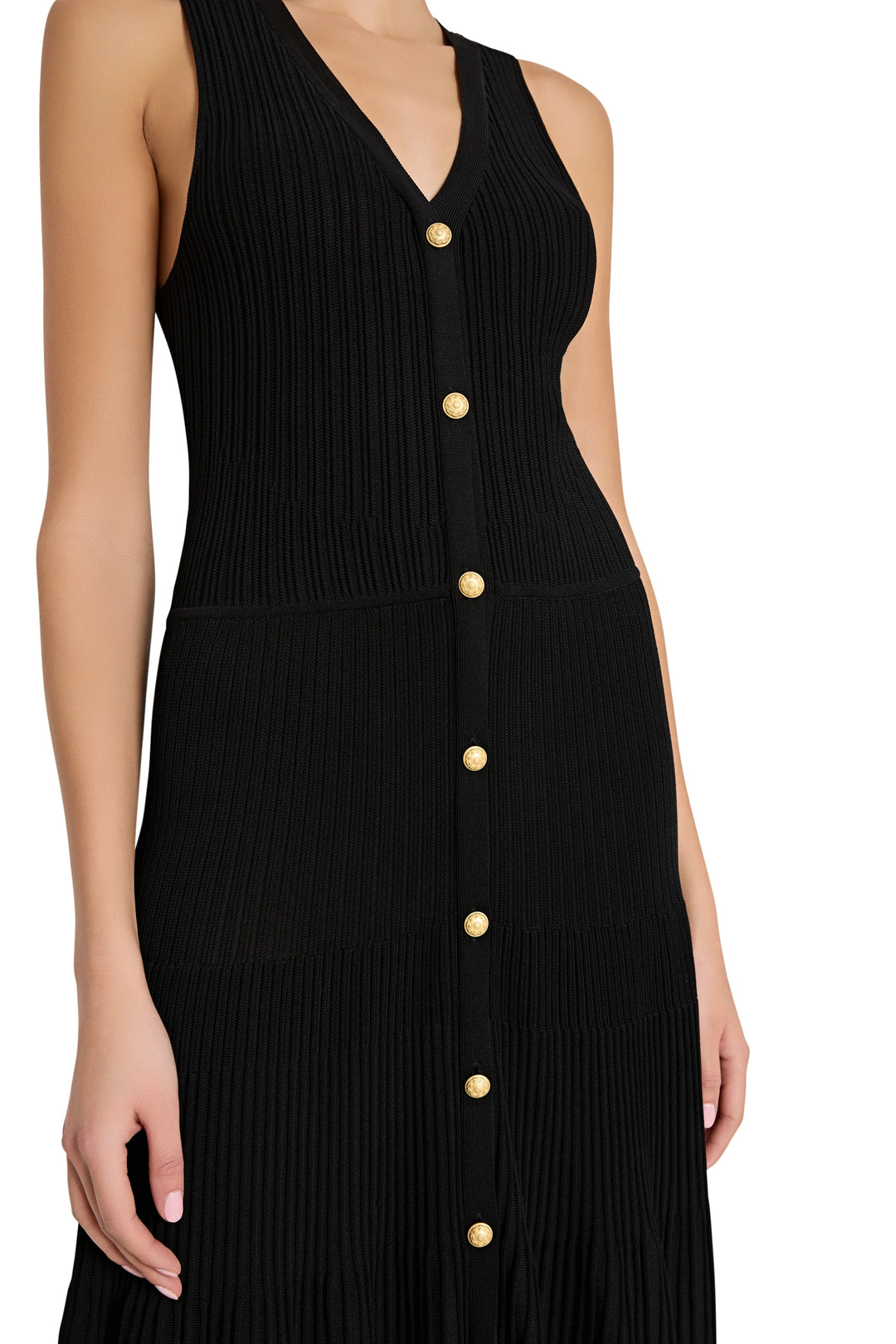 Black dress with gold buttons on a white background
