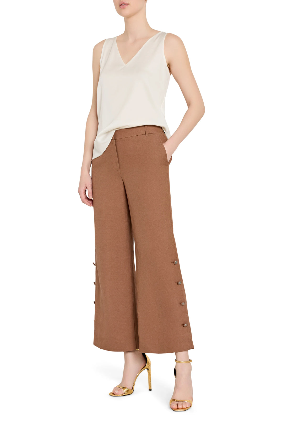 Wide-leg linen pants with artisan button detailing at front waist, structured silhouette; front view on model.
