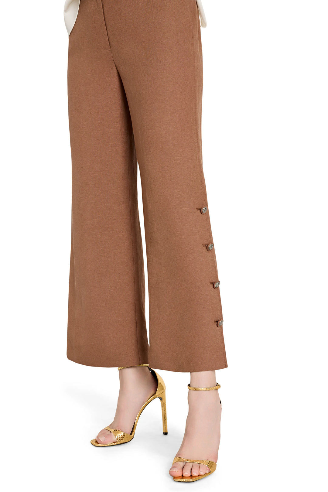 Wide-leg linen pants with artisan buttons and elastic back. Front view on white.
