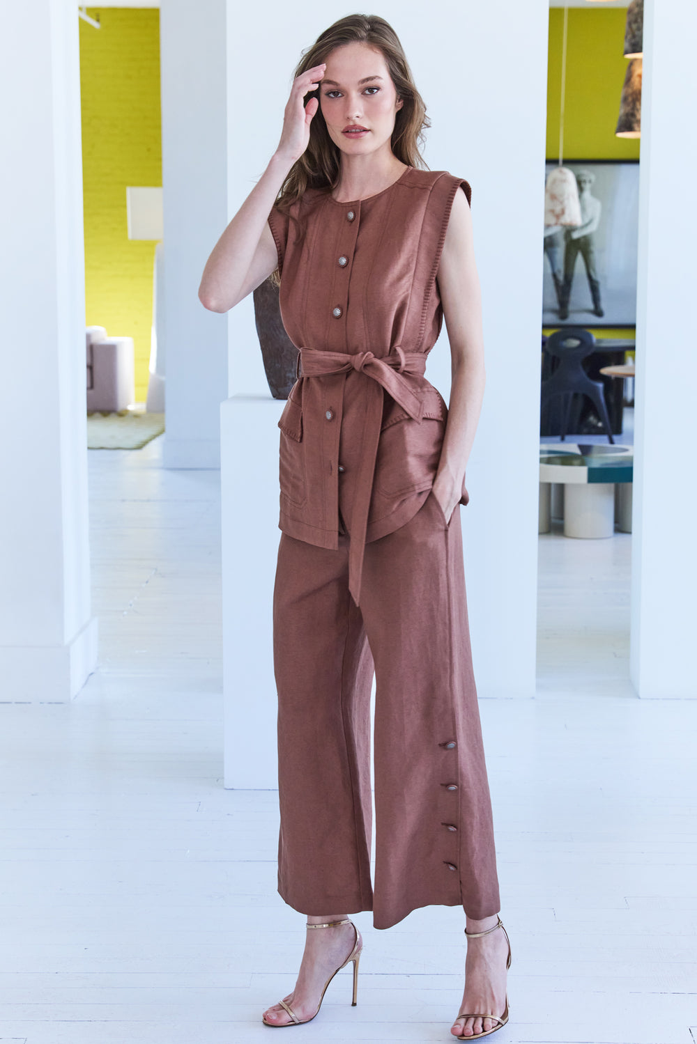 Wide-leg linen pant with artisan button, elastic back waistband; crisp tailored silhouette. Front view on model.