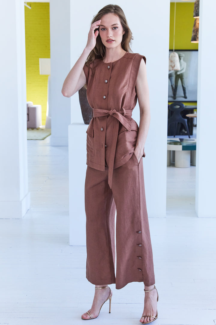 Wide-leg linen pant with artisan button, elastic back waistband; crisp tailored silhouette. Front view on model.