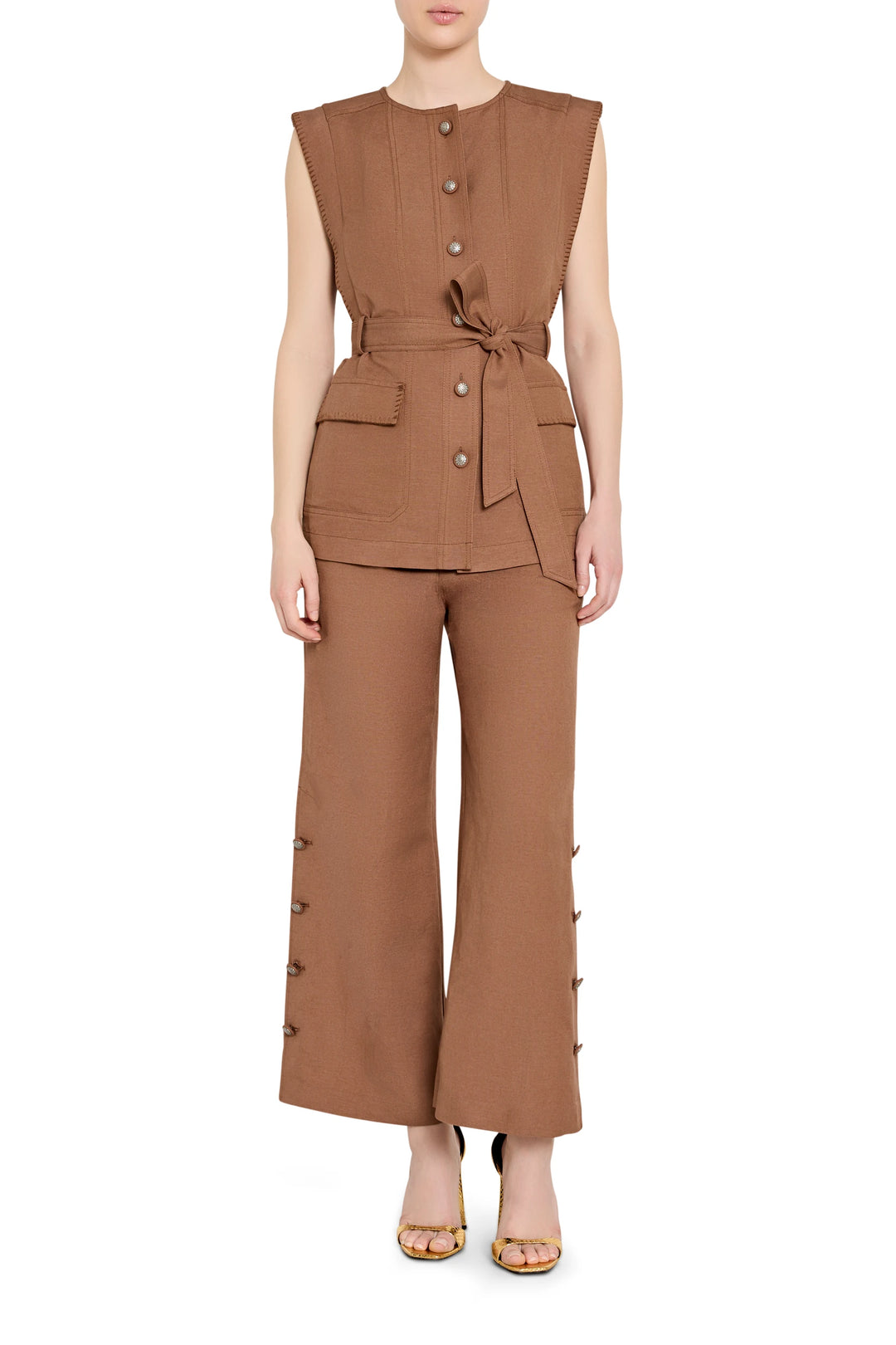 Sleeveless tailored linen vest with a belted waist and notched lapels, front view on model.