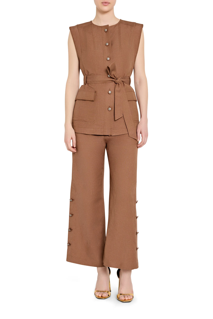 Sleeveless tailored linen vest with a belted waist and notched lapels, front view on model.