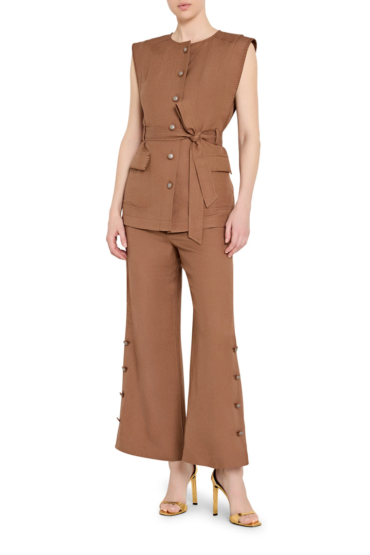 Sleeveless linen vest with belted waist, notched collar, and clean lines; front view on model.