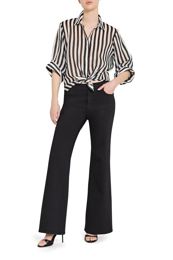 Person wearing a black and white striped shirt with black pants on a white background