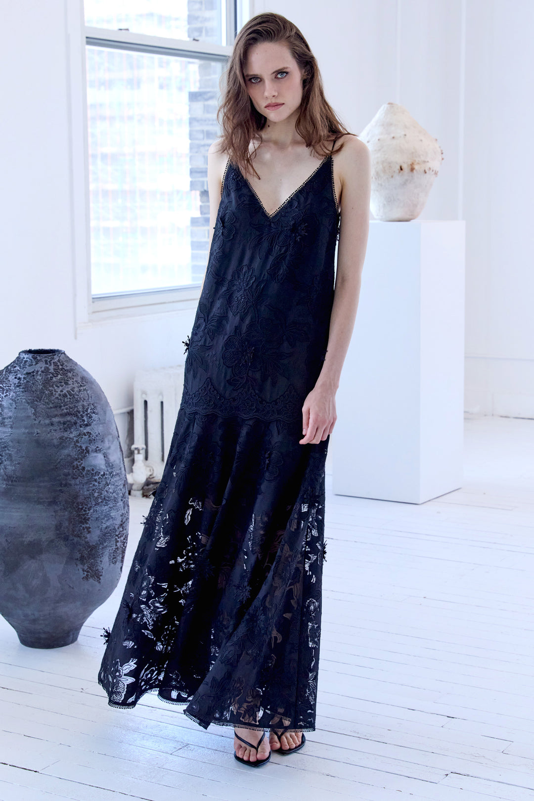 Maxi dress with fitted bodice, embroidered lace overlay, fluid skirt; front view on model.
